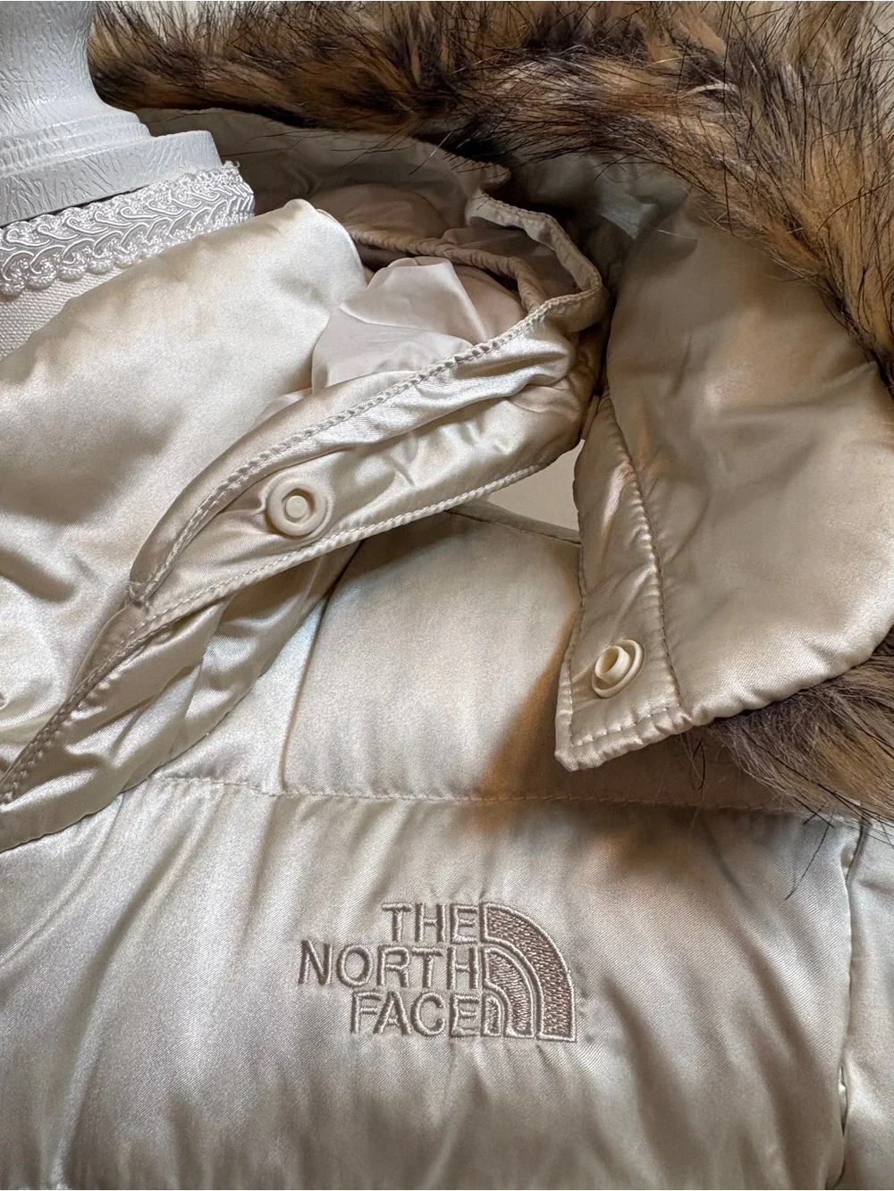 The North Face Girls champagne-colored puffer jacket